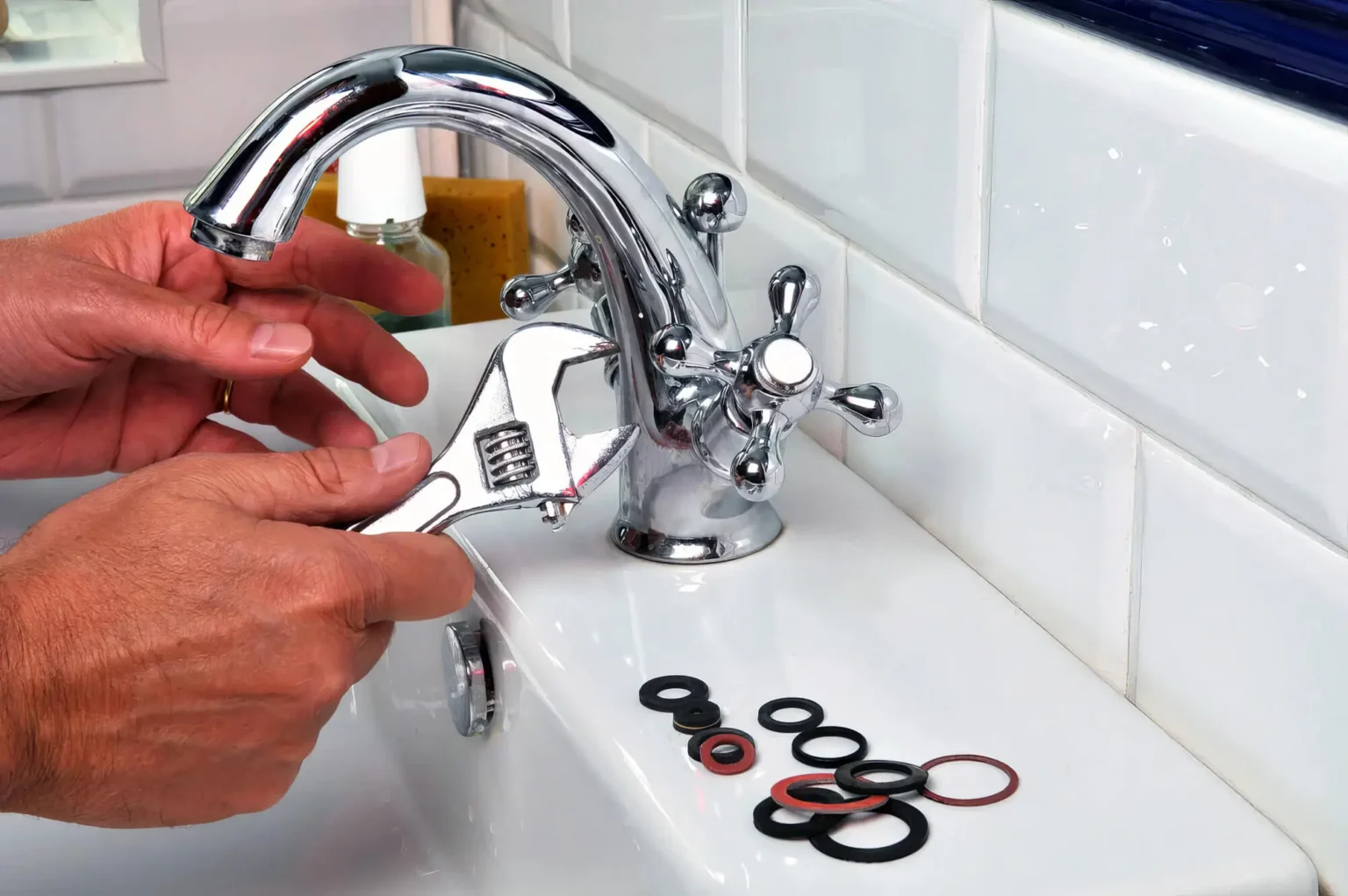 Plumber maintaining a bathroom faucet in Paramount
