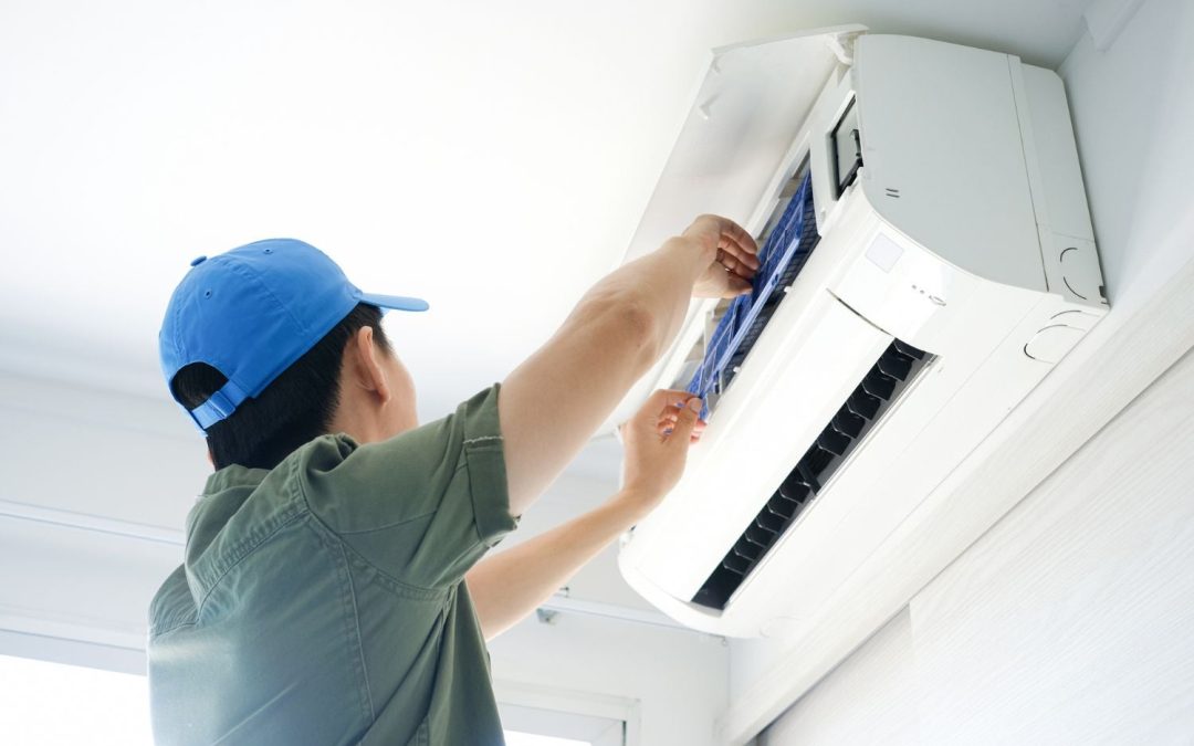 HVAC technician servicing a ductless mini split in Paramount