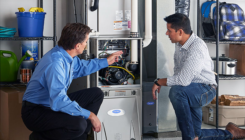 Technician evaluating a furnace for repair or replacement in Paramount